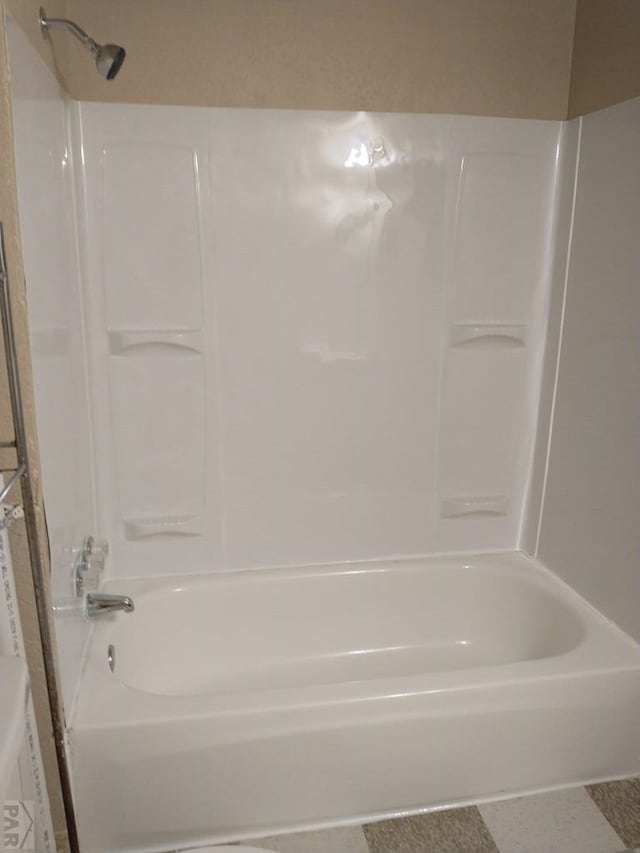 bathroom with tile patterned floors and bathing tub / shower combination