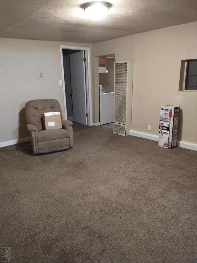 unfurnished room featuring carpet, a textured ceiling, and baseboards