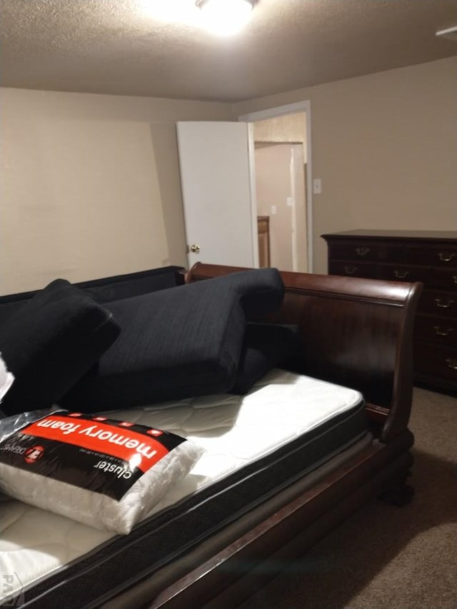 carpeted bedroom with a textured ceiling