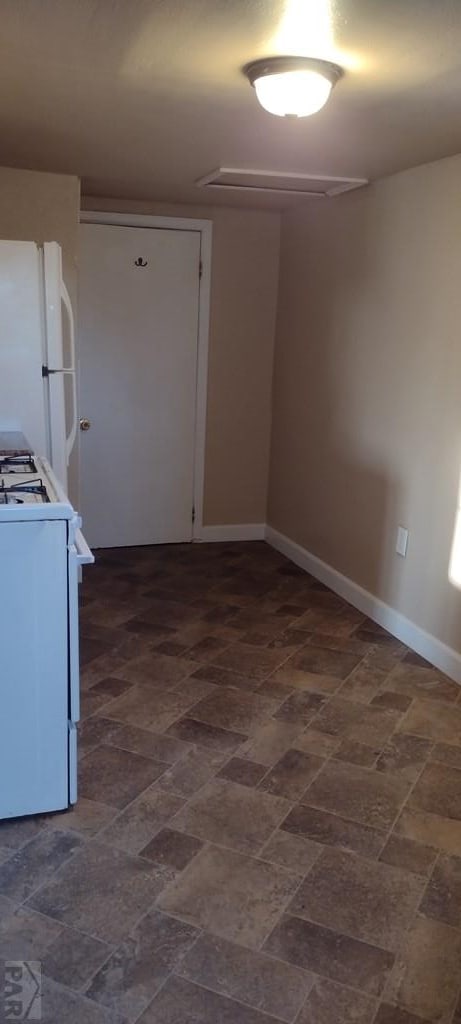 kitchen with white appliances and baseboards