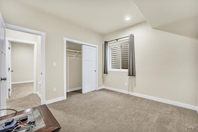 unfurnished bedroom featuring light carpet, recessed lighting, and baseboards