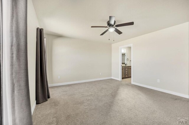 unfurnished room featuring baseboards, a ceiling fan, and light colored carpet