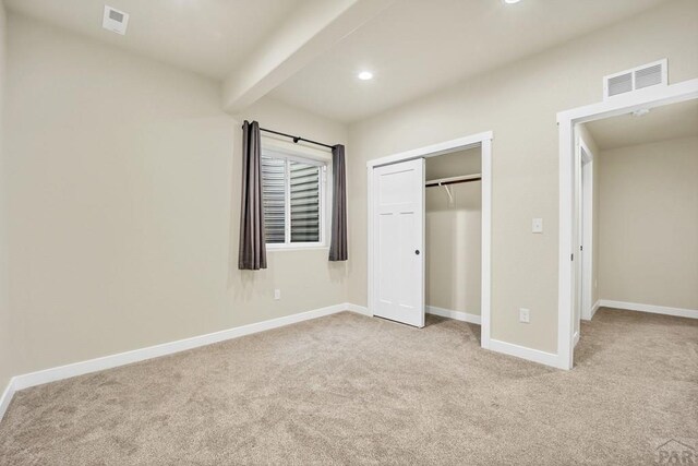 unfurnished bedroom with recessed lighting, visible vents, light carpet, beamed ceiling, and baseboards