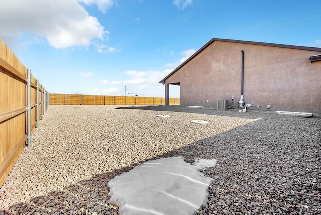 view of yard with cooling unit and a fenced backyard