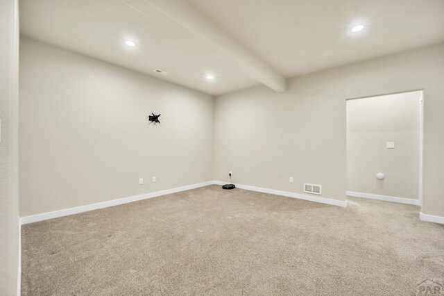 empty room with baseboards, beamed ceiling, visible vents, and recessed lighting