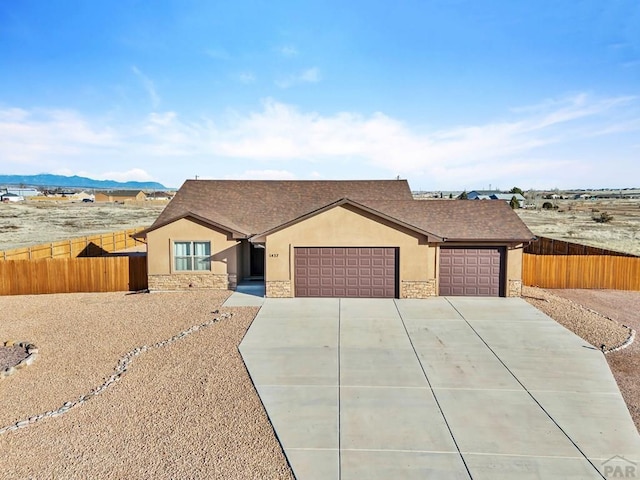 single story home featuring stone siding, fence, and stucco siding