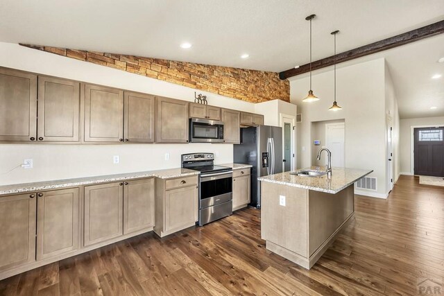 kitchen with visible vents, dark wood-style flooring, light stone countertops, stainless steel appliances, and a sink