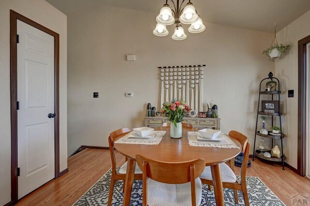 769 S Mccoy Dr, Pueblo West, CO 81007 - dining area featuring light wood finished floors, an inviting chandelier, and baseboards