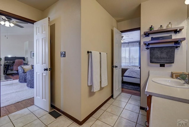 769 S Mccoy Dr, Pueblo West, CO 81007 - bathroom with vanity, baseboards, tile patterned flooring, a ceiling fan, and connected bathroom