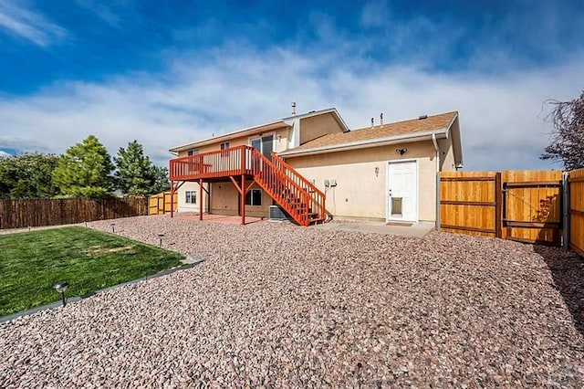 769 S Mccoy Dr, Pueblo West, CO 81007 - rear view of house featuring a wooden deck, a fenced backyard, stairway, a patio, and a gate
