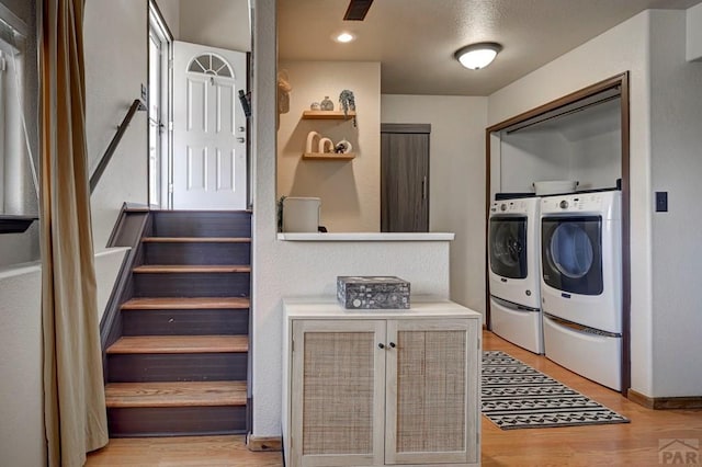 769 S Mccoy Dr, Pueblo West, CO 81007 - washroom with baseboards, light wood-style floors, visible vents, washer and clothes dryer, and laundry area