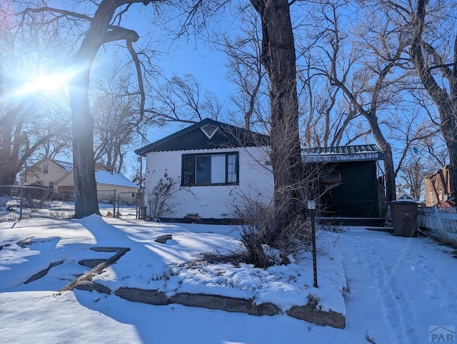 view of front of property featuring a garage and fence