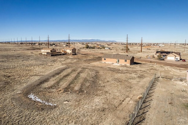 view of yard featuring a rural view and fence