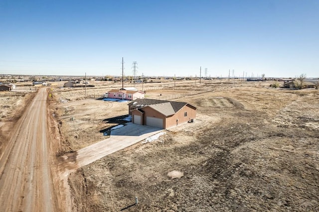 birds eye view of property with a rural view