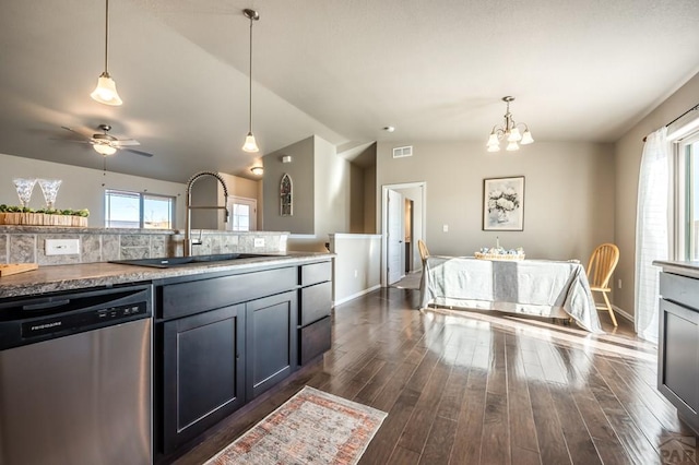 kitchen featuring lofted ceiling, dark wood-type flooring, a sink, hanging light fixtures, and stainless steel dishwasher