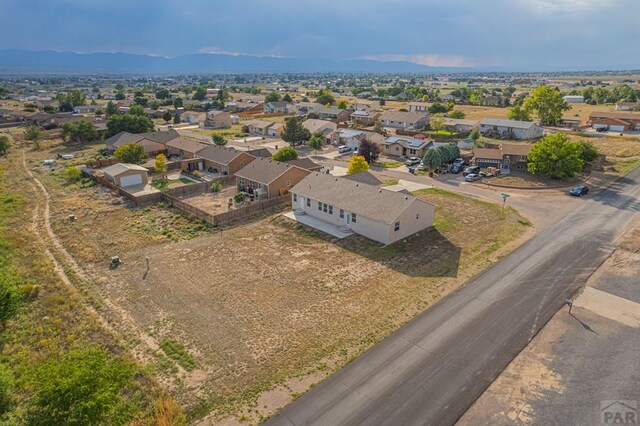 drone / aerial view featuring a residential view and a mountain view