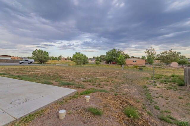 view of yard with a rural view and fence