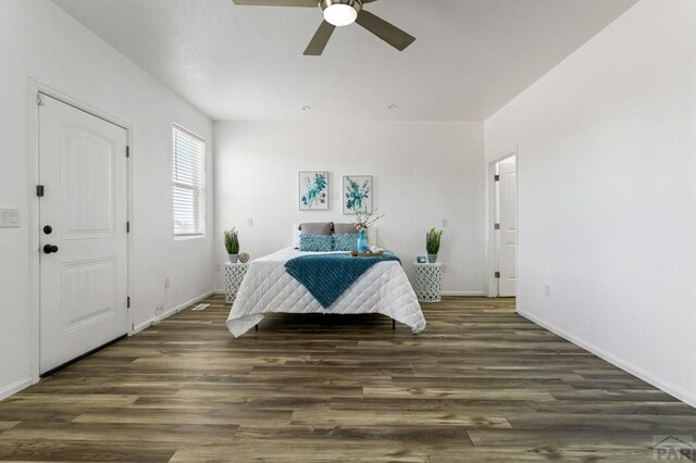 bedroom featuring ceiling fan, dark wood-style flooring, and baseboards