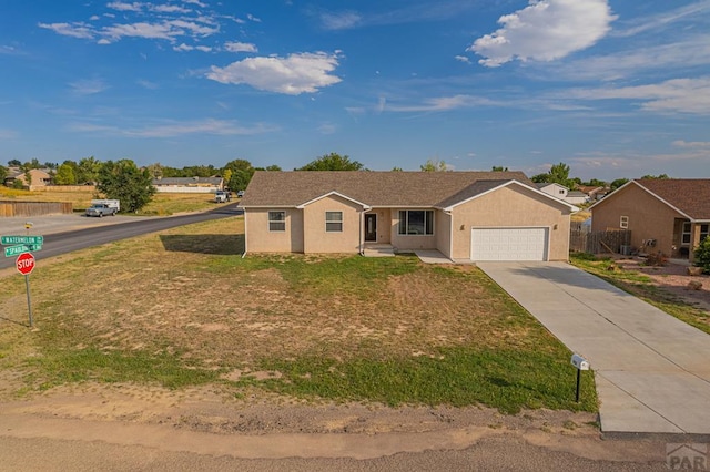 ranch-style house with driveway, a residential view, an attached garage, a front lawn, and stucco siding