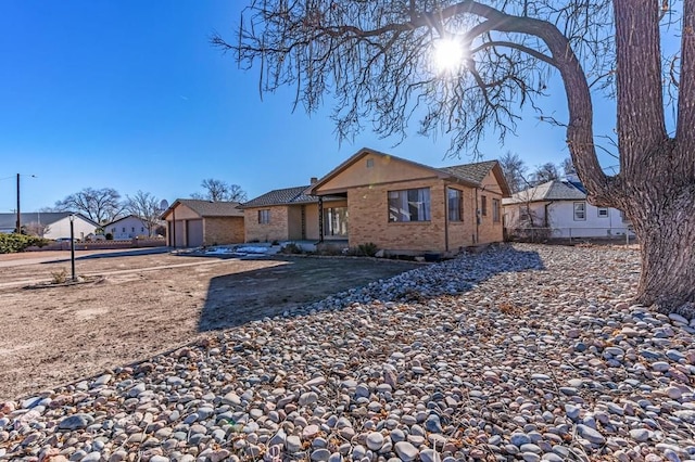 view of front of home with a residential view, fence, and brick siding