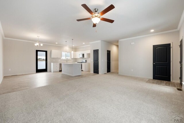 unfurnished living room with light carpet, crown molding, and recessed lighting