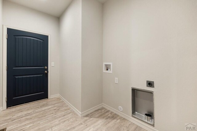 laundry area featuring light wood-style flooring, hookup for an electric dryer, laundry area, washer hookup, and baseboards