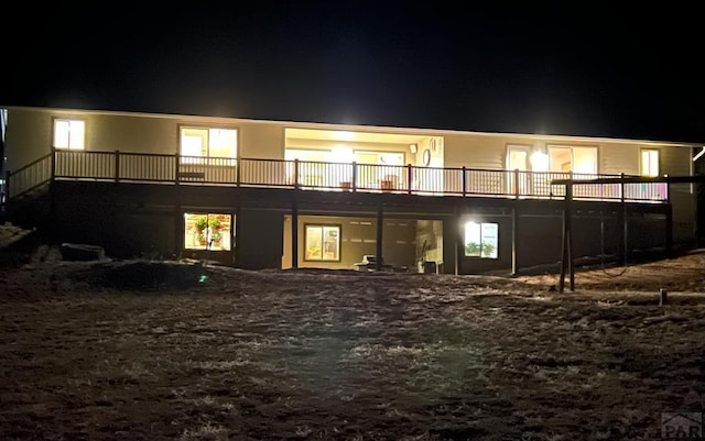 1771 Sunrise Rd, Walsenburg, CO 81089 - back of house at night featuring a wooden deck