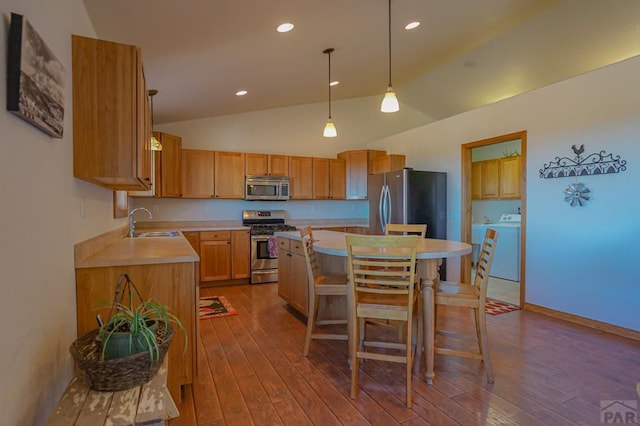 1771 Sunrise Rd, Walsenburg, CO 81089 - kitchen featuring dark wood finished floors, light countertops, appliances with stainless steel finishes, and a kitchen island