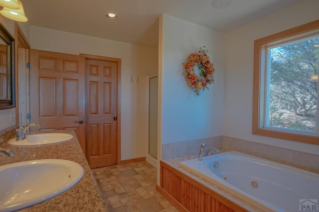 1771 Sunrise Rd, Walsenburg, CO 81089 - full bath with a sink, stone tile floors, double vanity, and a tub with jets
