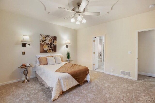 bedroom featuring baseboards, visible vents, connected bathroom, a ceiling fan, and light colored carpet