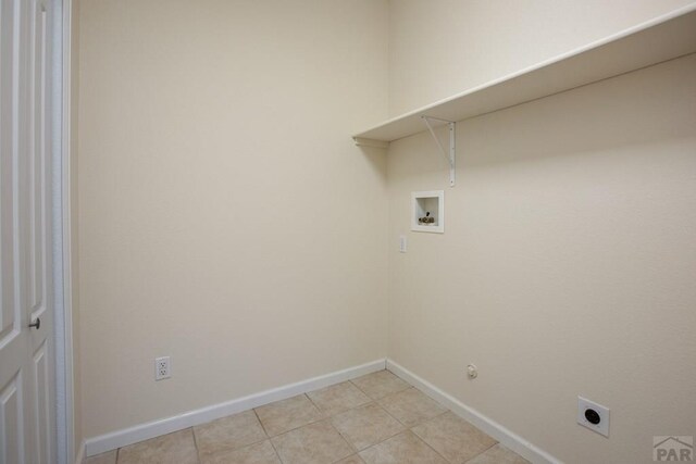 washroom with washer hookup, light tile patterned flooring, electric dryer hookup, laundry area, and baseboards