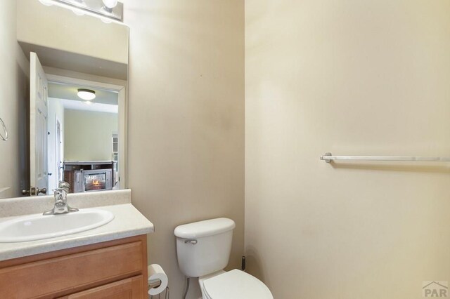 half bathroom with toilet and vanity