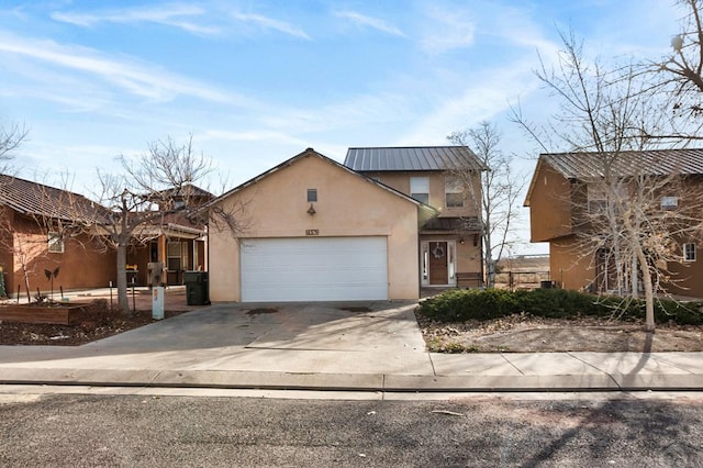 view of front of home with a garage, concrete driveway, and stucco siding