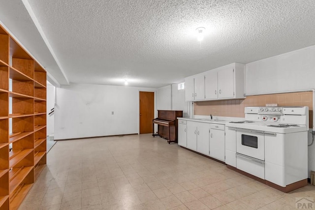 kitchen with a sink, white cabinetry, range with two ovens, and light countertops