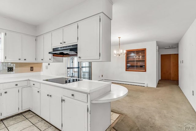 kitchen featuring decorative light fixtures, light countertops, white cabinets, under cabinet range hood, and black electric cooktop