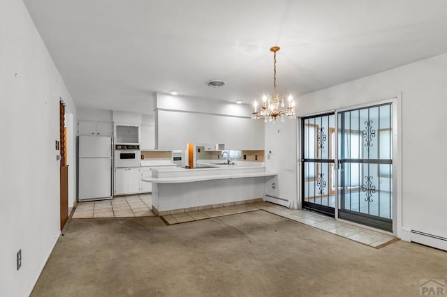 kitchen featuring white appliances, white cabinets, a peninsula, light countertops, and a baseboard heating unit