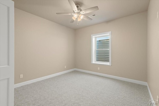 spare room featuring a ceiling fan, carpet flooring, visible vents, and baseboards