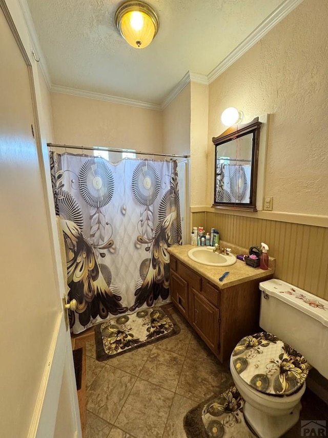 318 W 10th St, La Junta, CO 81050 - full bath with toilet, vanity, curtained shower, a wainscoted wall, and ornamental molding