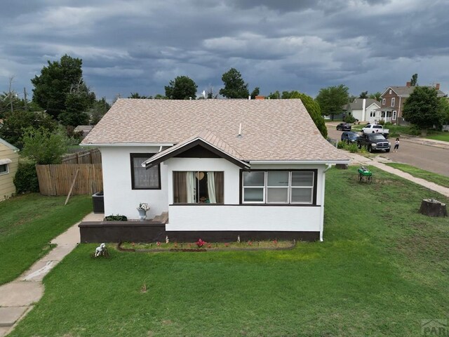 318 W 10th St, La Junta, CO 81050 - bungalow-style home with a shingled roof and stucco siding