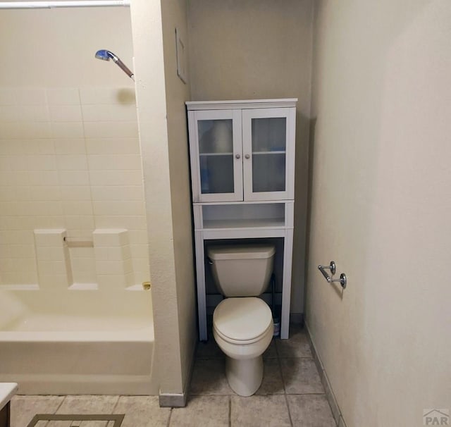 full bath featuring shower / tub combination, tile patterned flooring, toilet, and baseboards