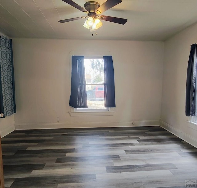 spare room featuring ceiling fan, baseboards, and wood finished floors