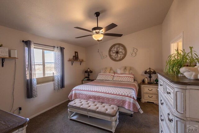 bedroom featuring ceiling fan, dark colored carpet, and baseboards