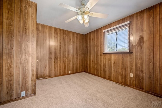 320 E Godding, Trinidad, CO 81082 - unfurnished room featuring ceiling fan, carpet flooring, and wood walls