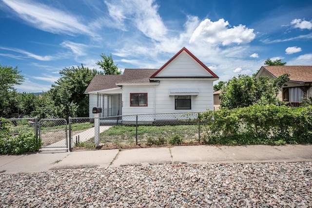 320 E Godding, Trinidad, CO 81082 - view of front of house with a gate, a fenced front yard, and roof with shingles