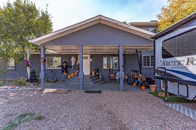 back of property featuring stucco siding