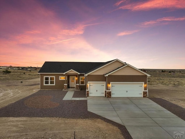 view of front facade featuring concrete driveway and an attached garage