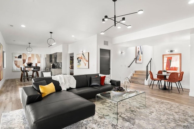 living area featuring stairway, recessed lighting, light wood-style floors, and visible vents