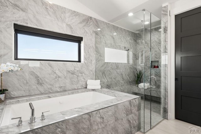 full bathroom featuring a garden tub and a shower stall