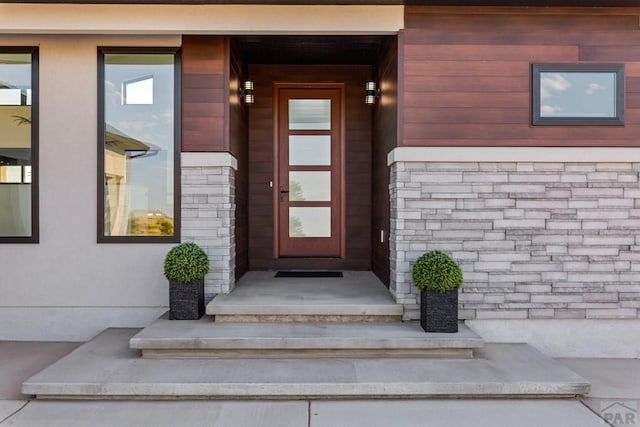 doorway to property with stone siding