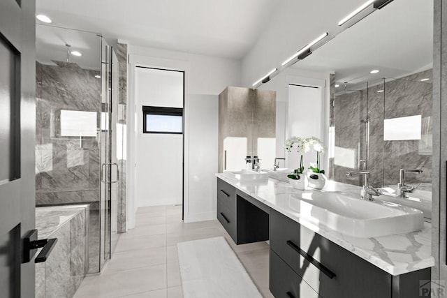 full bathroom with a sink, a shower stall, and double vanity